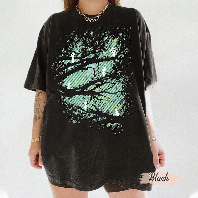 May include: Black oversized t-shirt featuring a tree design with white spirit figures. The graphic has a teal and yellow background. The shirt has short sleeves and a relaxed fit. The word "Black" is printed on the bottom right.
