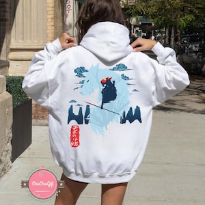 May include: White hoodie with a graphic design on the back. The design features a wolf-like figure, a character with a red head, and Japanese text. Blue clouds and mountain shapes complete the design.
