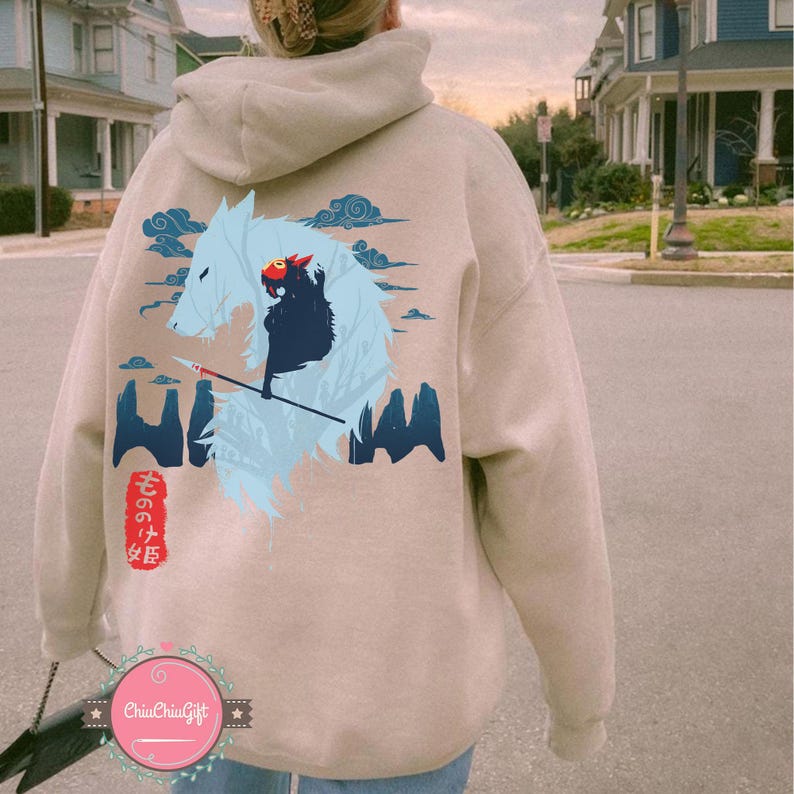 May include: Beige hoodie with a graphic of a wolf and a figure with a spear, with Japanese text. The design includes blue clouds and mountain-like shapes. The hoodie has a drawstring hood and a kangaroo pocket.