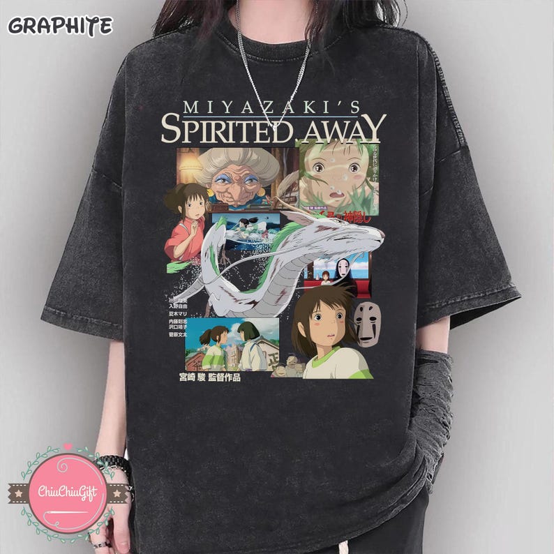 May include: Graphite-colored t-shirt featuring a collage of images from the animated film "Spirited Away." The design includes characters and the film's title. The shirt has short sleeves and a relaxed fit.