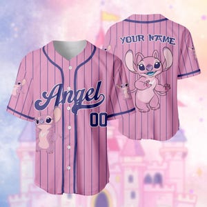 May include: Pink baseball jersey with vertical pinstripes and the word "Angel" in script. The jersey features a cartoon character and the number "00". The back of the jersey has the text "YOUR NAME".