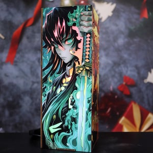 May include: A rectangular wooden lamp with an anime illustration. The artwork shows a character with black hair, green eyes, and a sword, with green and blue flames. The lamp emits a warm glow, creating a striking visual effect.