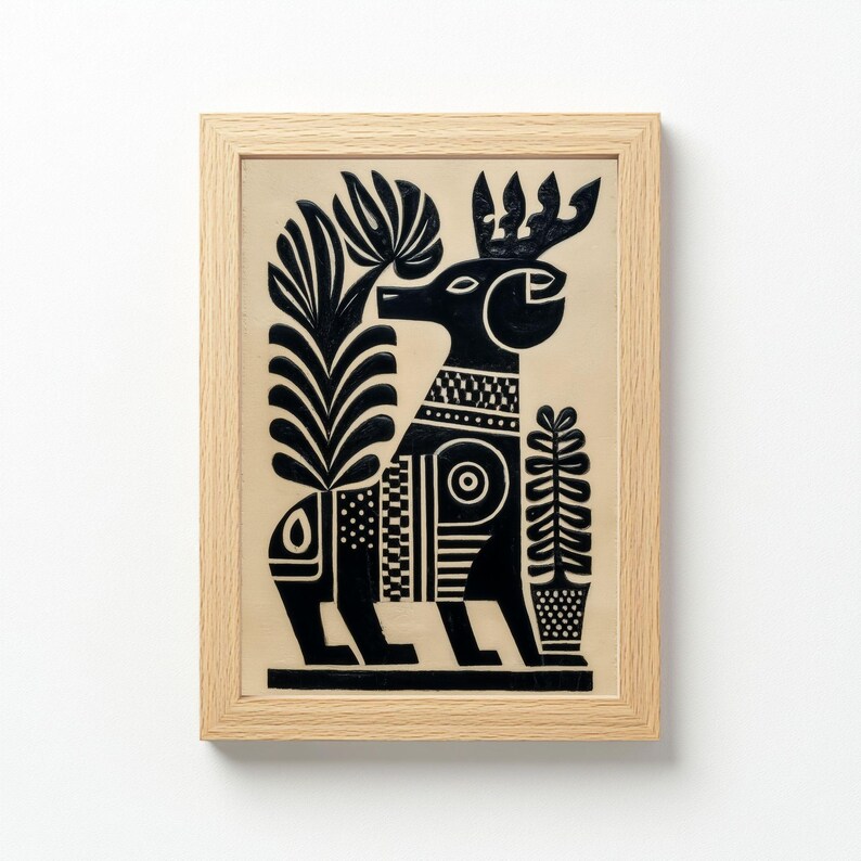 May include: Black and white folk art print of a stylized deer with large antlers, surrounded by stylized plants. The artwork is framed in a light wood frame. The deer has geometric patterns on its body and is set against a beige background.