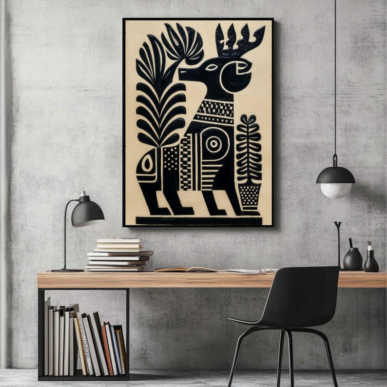 May include: Black and white art print featuring a stylized deer with large antlers and geometric patterns. The artwork includes plant-like elements on either side of the deer. The print is framed and displayed on a wall.