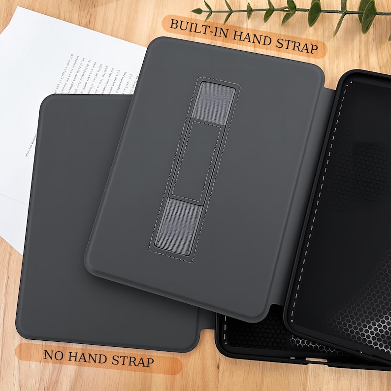 May include: Two gray tablet cases, one with a built-in hand strap and the other without. The case with the hand strap has a black elastic strap that is sewn into the case. The case without the hand strap has a smooth surface. Both cases have a black and white honeycomb pattern on the inside.