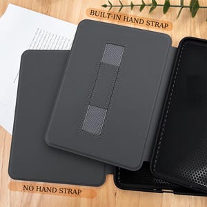 May include: A dark gray tablet case with a built-in hand strap and a stand. The case is open, revealing the interior and the text "BUILT-IN HAND STRAP" and "NO HAND STRAP". The case is designed to protect the tablet.