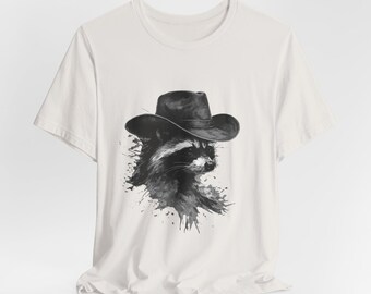 Maglietta grafica Cowboy Raccoon: maglietta con schizzi di inchiostro western