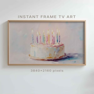 May include: A framed digital art print featuring a birthday cake with lit candles. The cake is white with colorful frosting and candles. The frame is a light wood color. Text at the top reads "INSTANT FRAME TV ART".