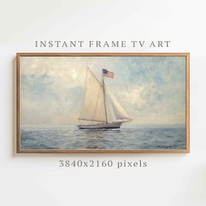 May include: A framed digital art print of a sailboat on the ocean. The artwork features a vintage style with a light blue sky and water. The American flag flies from the mast. Text at the top reads "INSTANT FRAME TV ART".