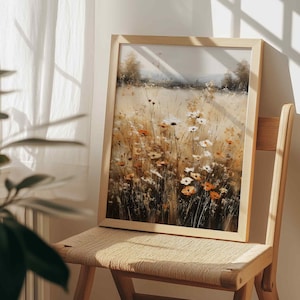 May include: A framed rectangular wall art print featuring an impressionistic painting of a sunlit meadow filled with tall grasses and wildflowers in shades of white, orange, and golden yellow, set within a light-toned wooden frame.