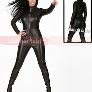 May include: A black leather jumpsuit with a zip-up front and long sleeves. The outfit is form-fitting and paired with platform boots. The image includes a smaller inset showing the back of the jumpsuit. Text on the image reads "Leather tab!" and "LEATHER STYLE".