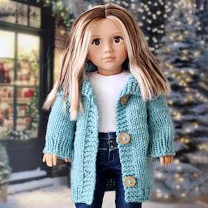 May include: A white ceramic mug with a black handle and the text "But First, Coffee" in a bold, black font. The mug is set against a blurred background, suggesting a cozy setting. The mug appears to be approximately 4 inches tall.