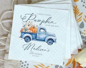 May include: White paper napkins with a baby shower design. The design features a light blue vintage truck carrying pumpkins and flowers. Text reads "A Sweet Little Pumpkin Is On The Way" and "Madison's Baby Shower 10.06.2025".