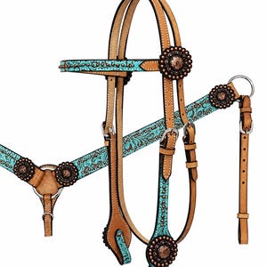 May include: A leather horse bridle and breast collar set featuring tan leather straps with turquoise floral overlays. The set is accented with round copper-toned conchos, silver-colored metal buckles, and white stitching along the edges.