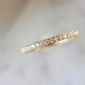 French pavé diamond band with .40ct GH/VS white round brilliant cut diamonds in 14k yellow gold. Floating pavé diamond ring with hand-cut v grooves for maximum sparkle. ¾ eternity band with solid gold bar for easy resizing. Available in 10k, 14k, and 18k solid gold in yellow, white, or rose. Customizable with lab-grown diamonds. Elegant stacking wedding band or minimalist engagement ring. Dainty, timeless, and handcrafted with luxe detail.