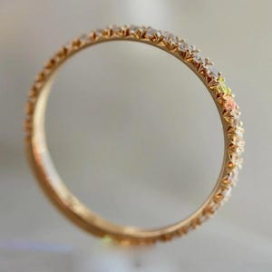 French pavé diamond band with .40ct GH/VS white round brilliant cut diamonds in 14k yellow gold. Floating pavé diamond ring with hand-cut v grooves for maximum sparkle. ¾ eternity band with solid gold bar for easy resizing. Available in 10k, 14k, and 18k solid gold in yellow, white, or rose. Customizable with lab-grown diamonds. Elegant stacking wedding band or minimalist engagement ring. Dainty, timeless, and handcrafted with luxe detail.