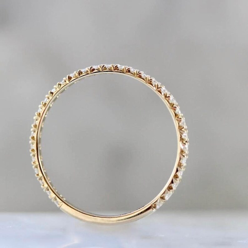French pavé diamond band with .40ct GH/VS white round brilliant cut diamonds in 14k yellow gold. Floating pavé diamond ring with hand-cut v grooves for maximum sparkle. ¾ eternity band with solid gold bar for easy resizing. Available in 10k, 14k, and 18k solid gold in yellow, white, or rose. Customizable with lab-grown diamonds. Elegant stacking wedding band or minimalist engagement ring. Dainty, timeless, and handcrafted with luxe detail.