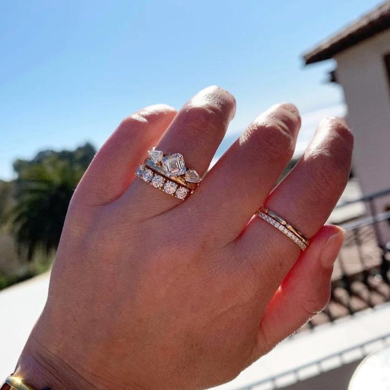 French pavé diamond band with .40ct GH/VS white round brilliant cut diamonds in 14k yellow gold. Floating pavé diamond ring with hand-cut v grooves for maximum sparkle. ¾ eternity band with solid gold bar for easy resizing. Available in 10k, 14k, and 18k solid gold in yellow, white, or rose. Customizable with lab-grown diamonds. Elegant stacking wedding band or minimalist engagement ring. Dainty, timeless, and handcrafted with luxe detail.