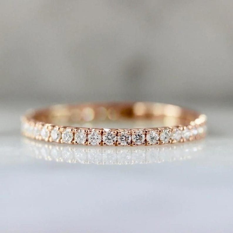 French pavé diamond band with .40ct GH/VS white round brilliant cut diamonds in 14k yellow gold. Floating pavé diamond ring with hand-cut v grooves for maximum sparkle. ¾ eternity band with solid gold bar for easy resizing. Available in 10k, 14k, and 18k solid gold in yellow, white, or rose. Customizable with lab-grown diamonds. Elegant stacking wedding band or minimalist engagement ring. Dainty, timeless, and handcrafted with luxe detail.