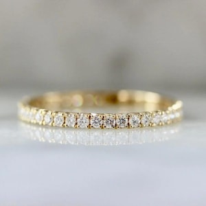 French pavé diamond band with .40ct GH/VS white round brilliant cut diamonds in 14k yellow gold. Floating pavé diamond ring with hand-cut v grooves for maximum sparkle. ¾ eternity band with solid gold bar for easy resizing. Available in 10k, 14k, and 18k solid gold in yellow, white, or rose. Customizable with lab-grown diamonds. Elegant stacking wedding band or minimalist engagement ring. Dainty, timeless, and handcrafted with luxe detail.