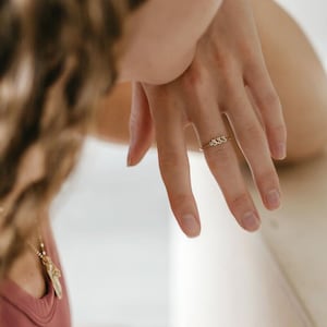 14K solid gold 333 angel number ring with a sparkling diamond accent, symbolizing divine guidance and alignment. This dainty, minimalist stacking ring blends celestial elegance with spiritual meaning, perfect as an engagement ring or thoughtful gift for her. Crafted in yellow, white, or rose gold, it's ideal for birthdays, anniversaries, or personal milestones. A timeless piece of fine jewelry with modern soul and subtle sparkle.