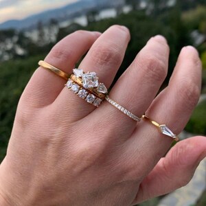 French pavé diamond band with .40ct GH/VS white round brilliant cut diamonds in 14k yellow gold. Floating pavé diamond ring with hand-cut v grooves for maximum sparkle. ¾ eternity band with solid gold bar for easy resizing. Available in 10k, 14k, and 18k solid gold in yellow, white, or rose. Customizable with lab-grown diamonds. Elegant stacking wedding band or minimalist engagement ring. Dainty, timeless, and handcrafted with luxe detail.
