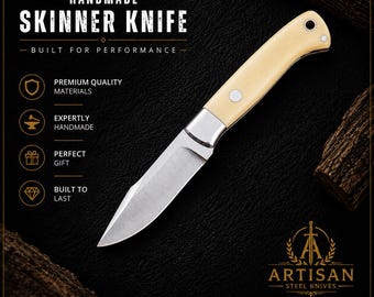 May include: Handmade Skinner knife with a cream-colored handle and a silver blade. The knife is labeled "Built for Performance" and features the text "Artisan Steel Knives". The design includes the words "Precision Engineered", "Sharp & Reliable", "Comfortable Grip", and "Timeless Design".