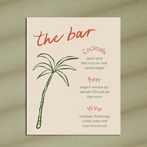 May include: A beige bar menu sign with red and green text and illustrations. The words "the bar" are at the top, with a palm tree illustration. Below are lists of cocktails, beer, and wine.