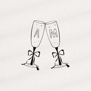 May include: A black and white line drawing of two champagne flutes clinking together. Each flute features a decorative bow tied around the stem and a single letter, A on the left and M on the right, centred within the glass bowl area.