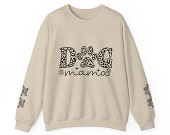 May include: A beige sweatshirt with a leopard print "Dog mama" design. The letters "D", "G" and the paw print are in a leopard print pattern. The words "mama" and two small paw prints are in black.