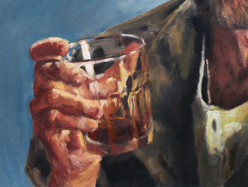 May include: A hand holding a clear glass with a brown liquid inside. The hand is wearing a brown jacket.