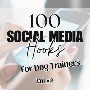 May include: Image of a smartphone displaying a light blue screen, with the text "100 SOCIAL MEDIA Hooks For Dog Trainers Vol #2" in black and white. The phone is held by a person with a blurred background.
