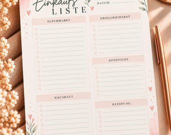 May include: A printed shopping list planner with the German text Einkaufsliste, Woche, Datum, Supermarkt, Drogeriemarkt, Sonstiges, Haushalt, and Kleidung. The paper features pink watercolor accents, small floral illustrations, and heart icons.