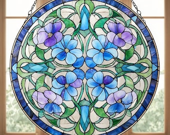 May include: A round stained glass window featuring a floral design. The window has a blue border and a central pattern of blue and purple flowers with green leaves. The glass is held together with dark metal framing, and the window is suspended by a chain.