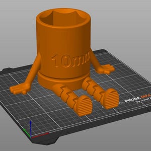 May include: An orange 3D-printed socket wrench with arms and legs, sitting on a black surface. The wrench is labeled "10mm". The design gives the wrench a cartoon-like appearance.