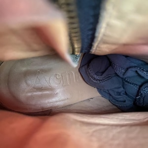 May include: Interior view of a tan leather boot with a dark blue fabric inside. The word "Avenger" is embossed on the insole. A zipper is visible along the side of the boot.