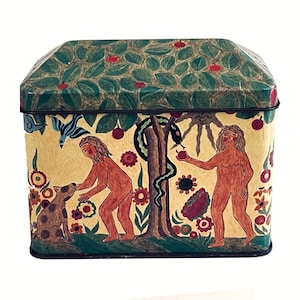 May include: A rectangular tin box with a hinged lid, featuring a painted scene of figures, a dog, and a snake near a tree. The lid is green with red berries, and the sides have a yellow background with colorful floral and figurative elements.