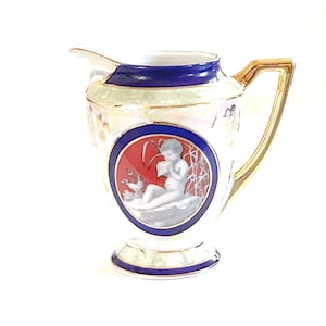 May include: A set of three ceramic mugs with a speckled, matte finish. The mugs are in shades of cream, light gray, and dark gray. Each mug has a simple, minimalist design and a rounded handle.