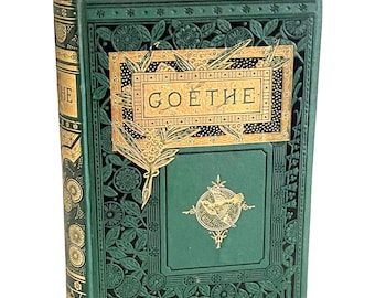 May include: A green hardcover book titled GOETHE with intricate embossed floral patterns and gold foil accents on the front cover and spine. The cover features a central circular emblem with a bird illustration and a rectangular gold label.