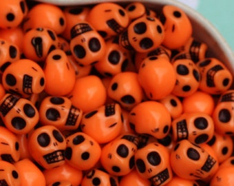 50x Small Orange and Black Acrylic Skull Beads 10mm by 8mm .. Halloween and Day of the Dead