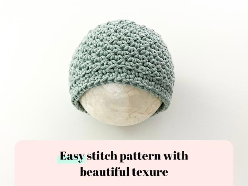 May include: A sage green crocheted beanie hat with a textured stitch pattern. The hat is displayed on a white surface.