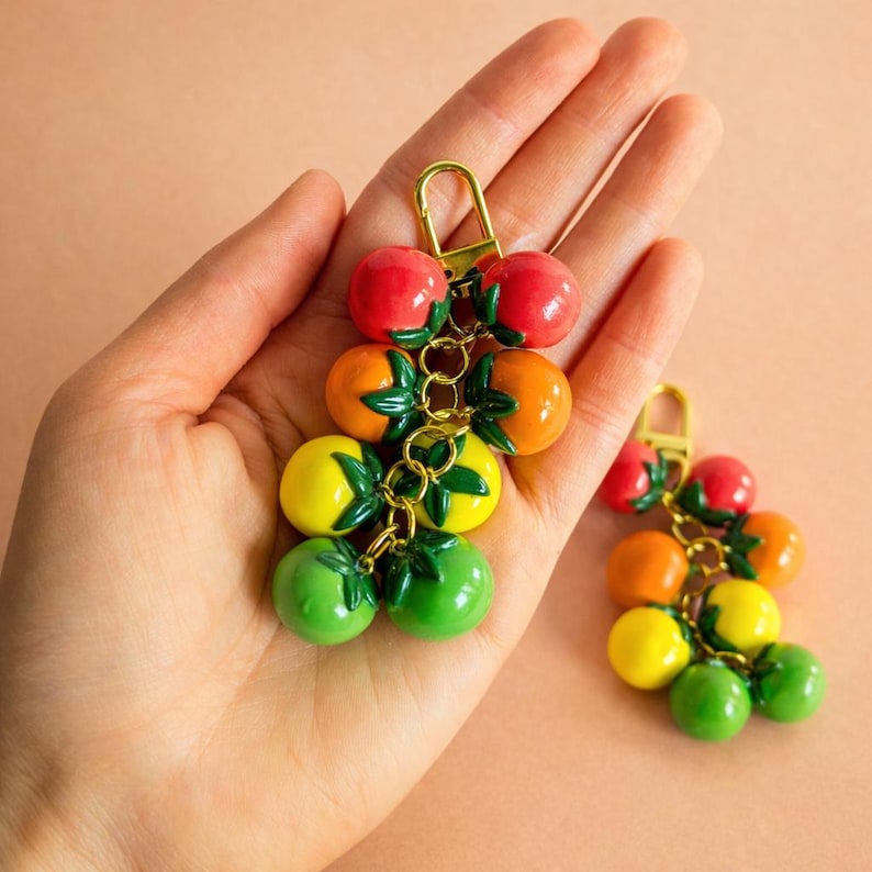 Cherry tomato keychain bag accessory crafted from handmade polymer clay fruit beads in vibrant colors. Functional key ring, purse charm, and backpack zipper pull for everyday use. Cute tomato gift for garden lovers, cottagecore fans, and maximalist fruit accessory lovers.