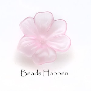 May include: A pale pink flower-shaped bead with five petals. The bead is made of translucent plastic and has a slightly frosted finish.