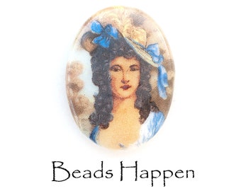 May include: Oval-shaped glass cabochon featuring a vintage image of a woman wearing a blue and white hat and a blue dress. The image is surrounded by a white border.
