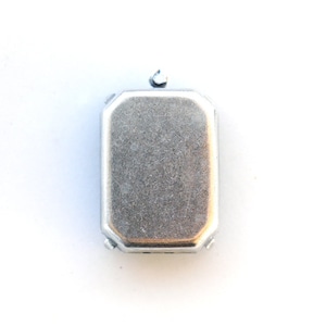 May include: A silver metal electrical box with a rectangular shape and a rounded top.
