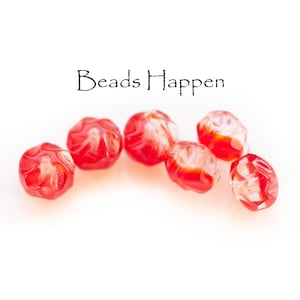 May include: Seven red glass beads with white swirls. The beads are faceted and have a translucent appearance. The beads are arranged in a semi-circle on a white background. The text "Beads Happen" is written above the beads.