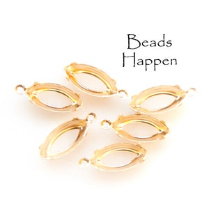 May include: Six gold-toned metal settings for marquise-shaped stones. The settings have a small loop on one end for attaching to jewelry.