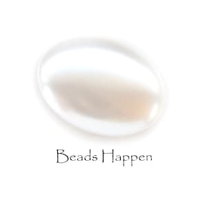 May include: A white oval-shaped glass bead with a smooth, shiny surface.