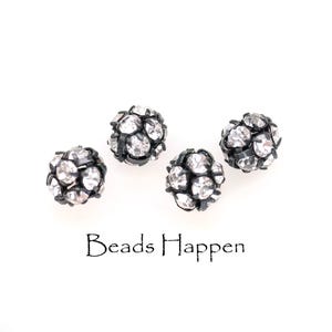 May include: Four black and silver round beads with rhinestones. The beads are scattered on a white surface. The text "Beads Happen" is printed below the beads.
