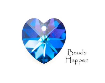 May include: A blue crystal heart charm with a hole for stringing. The charm is faceted and has a starburst pattern.